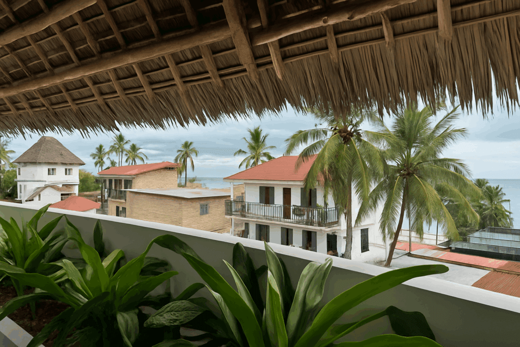 Shaded outdoor seating area with palm trees at ÔTALIA Hotel Restaurant